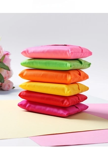 Detail of colorful foldable oxford cloth shopping bags in six bright assorted colors