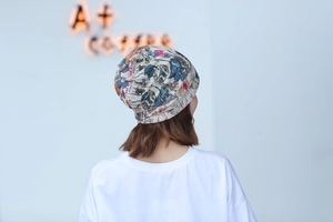 Detail of colorful graffiti print headwear showing rear view of the stylish beanie hat