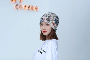 Detail of soft breathable beanie with colorful illustration print on white knit fabric