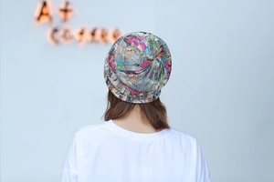 Detailed back view of a soft floral graffiti print beanie cap worn by a model