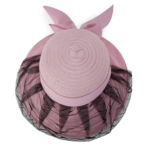 Women's pink straw sun hat with black lace mesh veil and large bow for summer beach travel