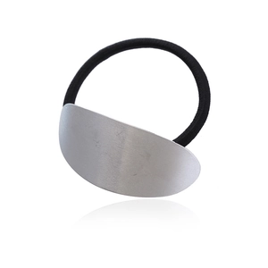 Minimalist elastic hair tie with a silver oval brushed metal plate on white background
