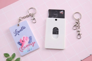 Detail of flamingo card holder with spring clip keychain and pink plaid background
