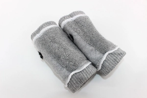Close-up of breathable gray cotton baby knee pads with soft terry texture and embroidery