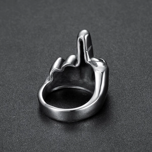 Macro detail of silver vintage stainless steel ring with middle finger gesture design