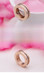 Detailed view of rose gold magnetic therapy ring with sparkling white zircon inlay
