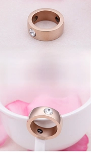Close-up of rose gold stainless steel ring with zircon stone and inner magnetic elements