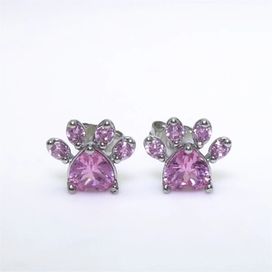Macro shot of cat paw earrings with pink heart-shaped crystal and silver metal base