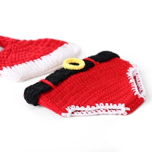 Detail of handmade knit Christmas hat and diaper cover set for newborn photography