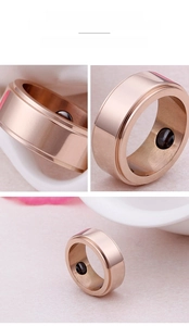 Rose gold magnetic ring detail with brushed metal finish and inlaid black magnets