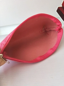 Detailed interior view of the pink cosmetic bag showing spacious lining and zipper