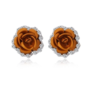 Macro view of orange rose stud earrings with white cubic zirconia and silver base