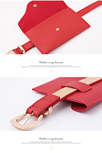 Detail view of red pebble leather fanny pack with gold buckle and envelope closure