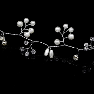 Macro detail of bridal hair vine with silver wire, white pearls and clear crystals