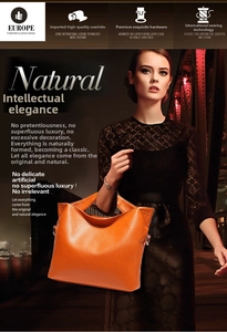 Close-up of orange litchi grain leather tote bag featuring five-layer electroplated hardware