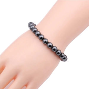 Detail of 8mm black magnetic hematite beaded bracelet on a display hand model
