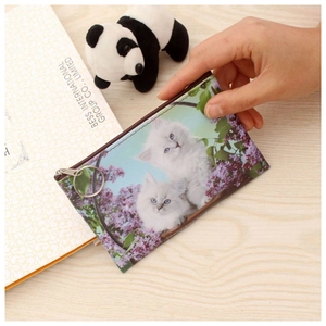 Detail of slim cat coin purse featuring a zipper, silver ring, and floral kitten print