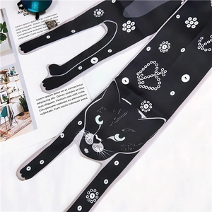 Detail showing cartoon black cat pattern and small white flowers on the long silk scarf