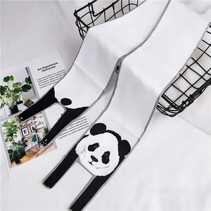 Detailed close-up of a white silk scarf with cute panda patterns and minimalist decor