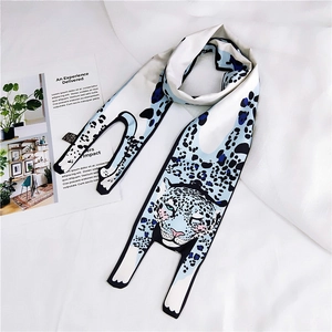 Detail of light blue leopard print silk scarf with cute cartoon animal character