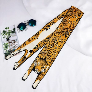 Detail of leopard print long silk scarf with artistic leopard head illustration