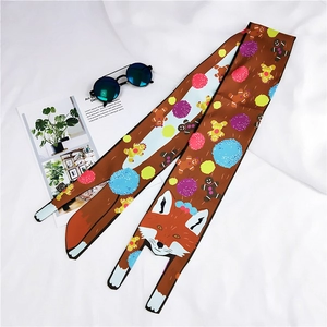 Detail of silk scarf with fox and gingerbread man prints on brown background