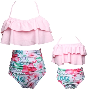 Detail of pink ruffle top and tropical floral print bikini bottoms for matching swimwear