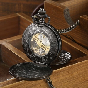 Macro view of vintage mechanical pocket watch with hollow floral carving and gold movement