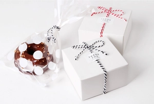 Detail showing gift packaging with cotton twine, thank you stickers and treat boxes