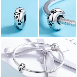 Macro shot of silver S925 sterling silver bead with black paw prints for DIY bracelets