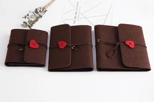 Detailed comparison of three different sizes of brown felt DIY albums with red heart buttons