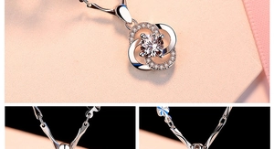Detailed view of silver clover pendant with central crystal and sparkling pavé accents
