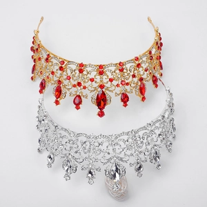 Detail view of gold and silver Baroque tiaras with red and clear crystal rhinestones
