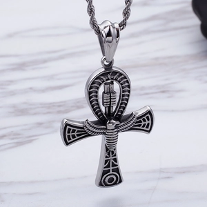 Silver Egyptian Ankh necklace pendant with embossed scarab wings on marble surface