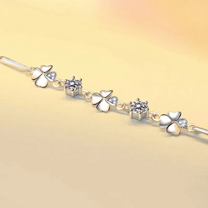 Detailed macro of silver four-leaf clover bracelet with sparkling zircon stones