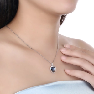 Elegant s925 sterling silver heart necklace with blue crystal on female model