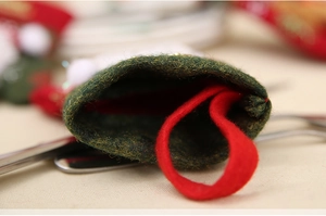 Macro view of green felt Christmas stocking detail with a red hanging loop for cutlery