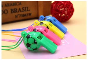 Detailed view of colorful soccer-shaped plastic whistles with matching lanyards