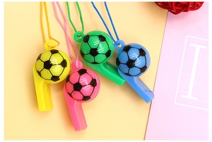 Detailed view of colorful plastic soccer whistles with matching lanyards in four bright colors