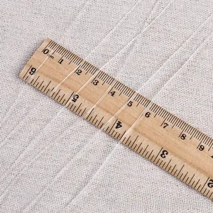 Macro detail of ultra-fine transparent elastic jewelry thread measured on a ruler