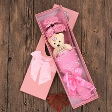 Pink gift box with a plush teddy bear, carnations, and a Daily Happiness wooden sign