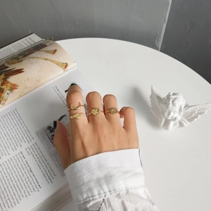 Detail view of 925 silver gold rings with moon and ruby star charms on model hand
