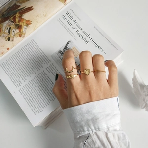 Macro detail of a 4-piece vintage gold ring set with crescent and BABY engraving
