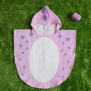 Close-up of pink cotton toddler hooded towel with white snaps and soft terry cloth texture