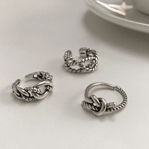 Macro shot of 925 sterling silver ring set featuring braided and chain-link textures