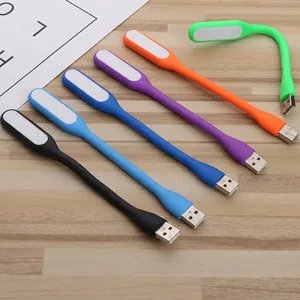Set of six colorful flexible USB LED night lights in silicone on a wooden surface