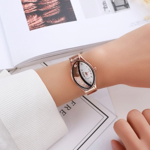 Detail of rose gold oval quartz watch with floating crystals on woman's wrist