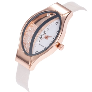 Close-up of rose gold oval watch case with white dial and floating crystal sand effect