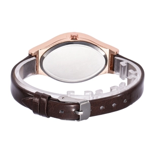 Polished rose gold case back and brown leather strap detail of a minimal quartz watch