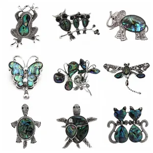 Collection of retro animal brooches featuring inlaid natural colorful paua shell details